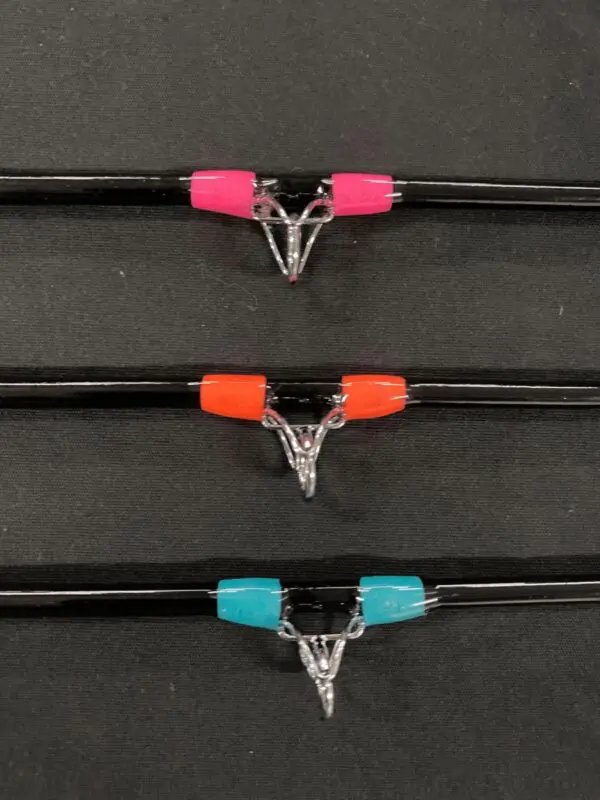 A row of three different colored wires with clips.