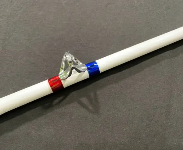A red, white and blue pencil with a sharpener on it.