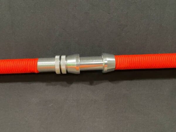 A close up of the end of an orange hose