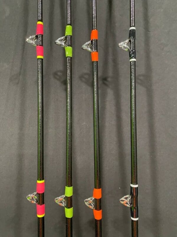 A group of four poles with different colored handles.