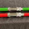 Two green and red hose with a metal handle.